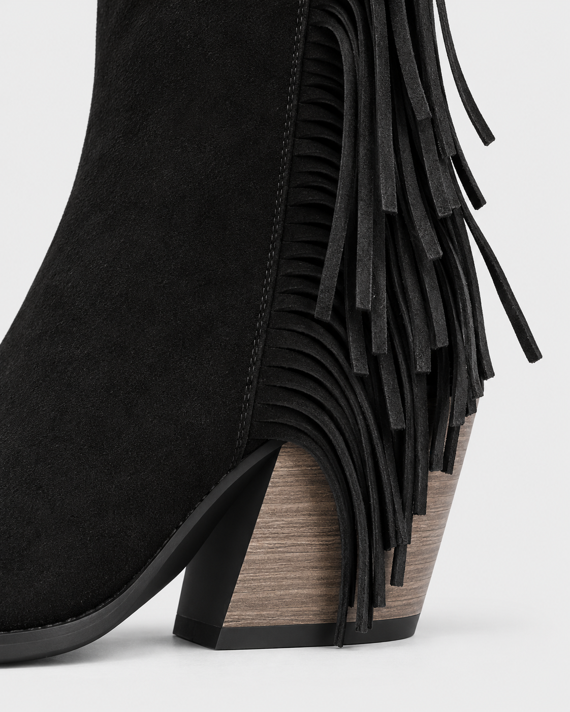 Black | Close-up of block heel and western tassels on ankle boot