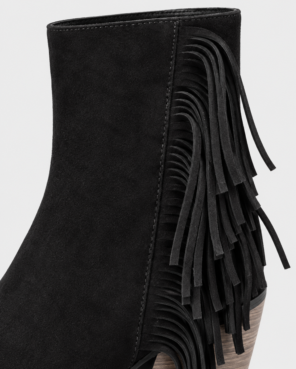 Black | Close-up of cascading tassel fringe on black ankle boot
