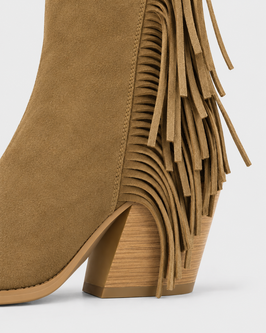 Earth Yellow | Close-up of block heel and tassel fringe on tan western boot