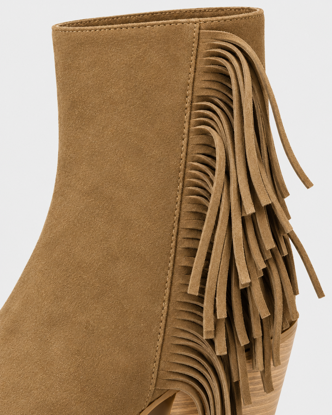 Image of Earth Yellow | Close-up of decorative fringe on women's western ankle boot