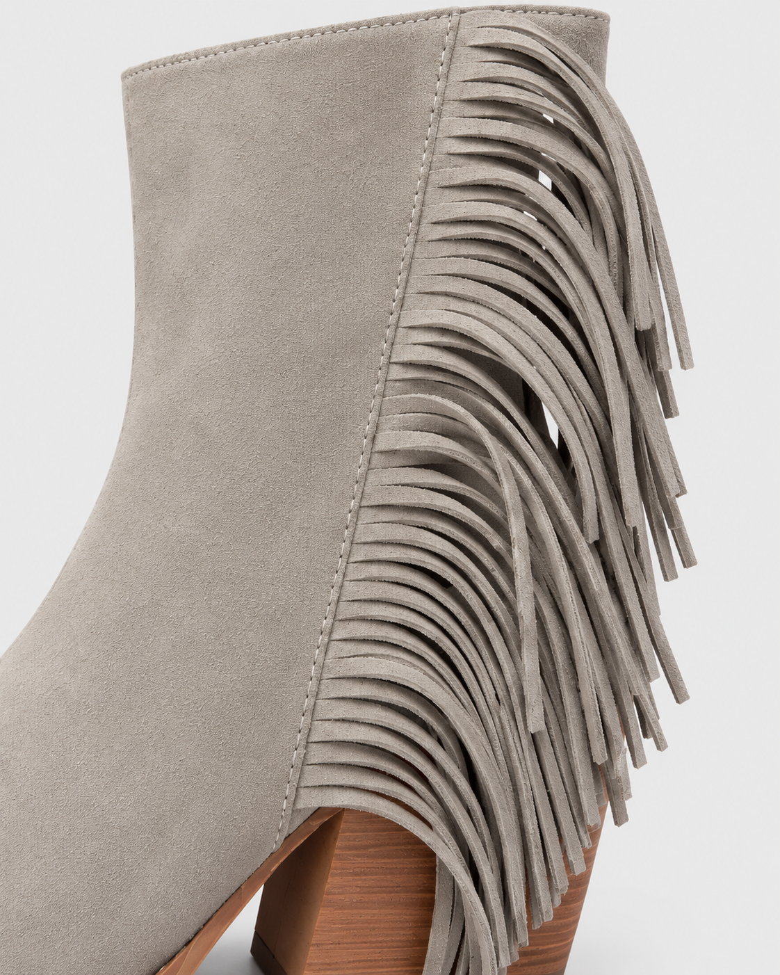 Image of Gray | Close-up of block heel and decorative tassels on western ankle boot