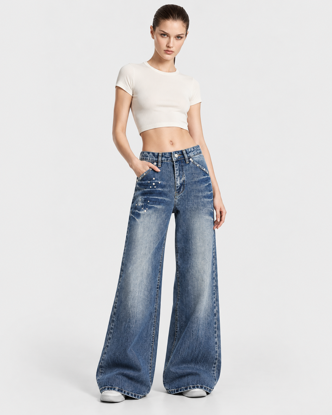 Blue | Model wearing blue washed rivet wide-leg jeans, front studio pose