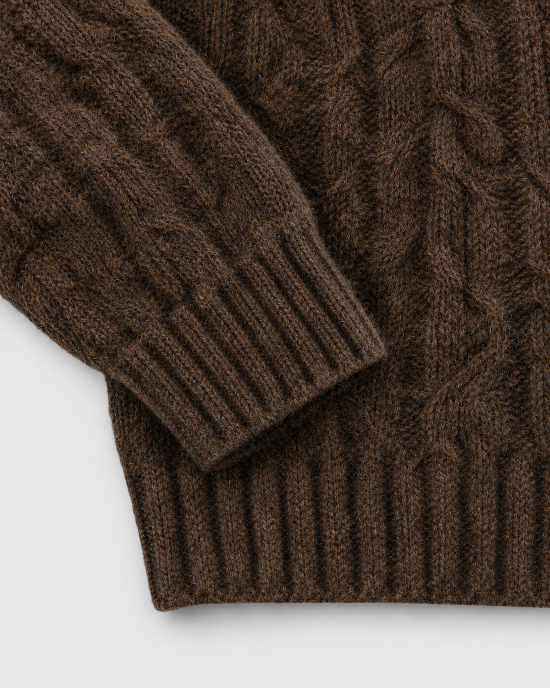 Image of Coffee | Close-up of the ribbed cuff and hem on cable-knit sweater