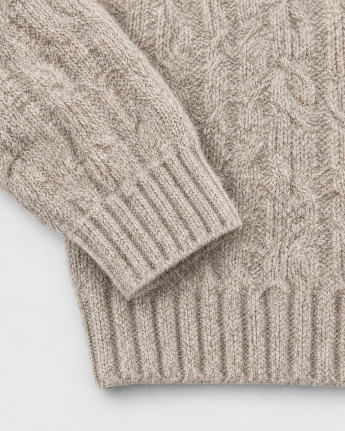 Image of Oatmeal | Close-up of the ribbed cuff and hem on cable-knit sweater