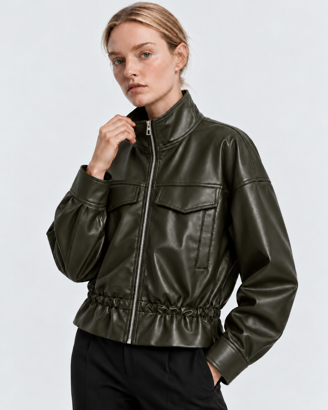 Image of Color: Army Green | Women's army green stand collar faux leather zip-up jacket styled on model, three-quarter view