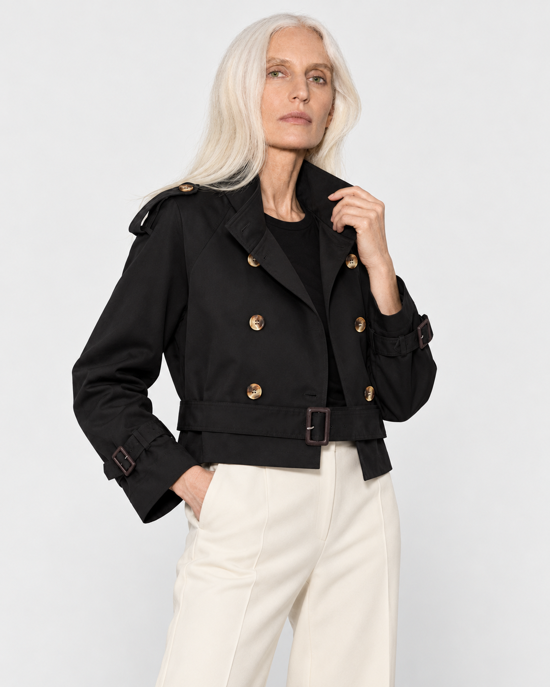 Image of Color: Black | Women's black short double-breasted belted trench coat styled on model, look 2
