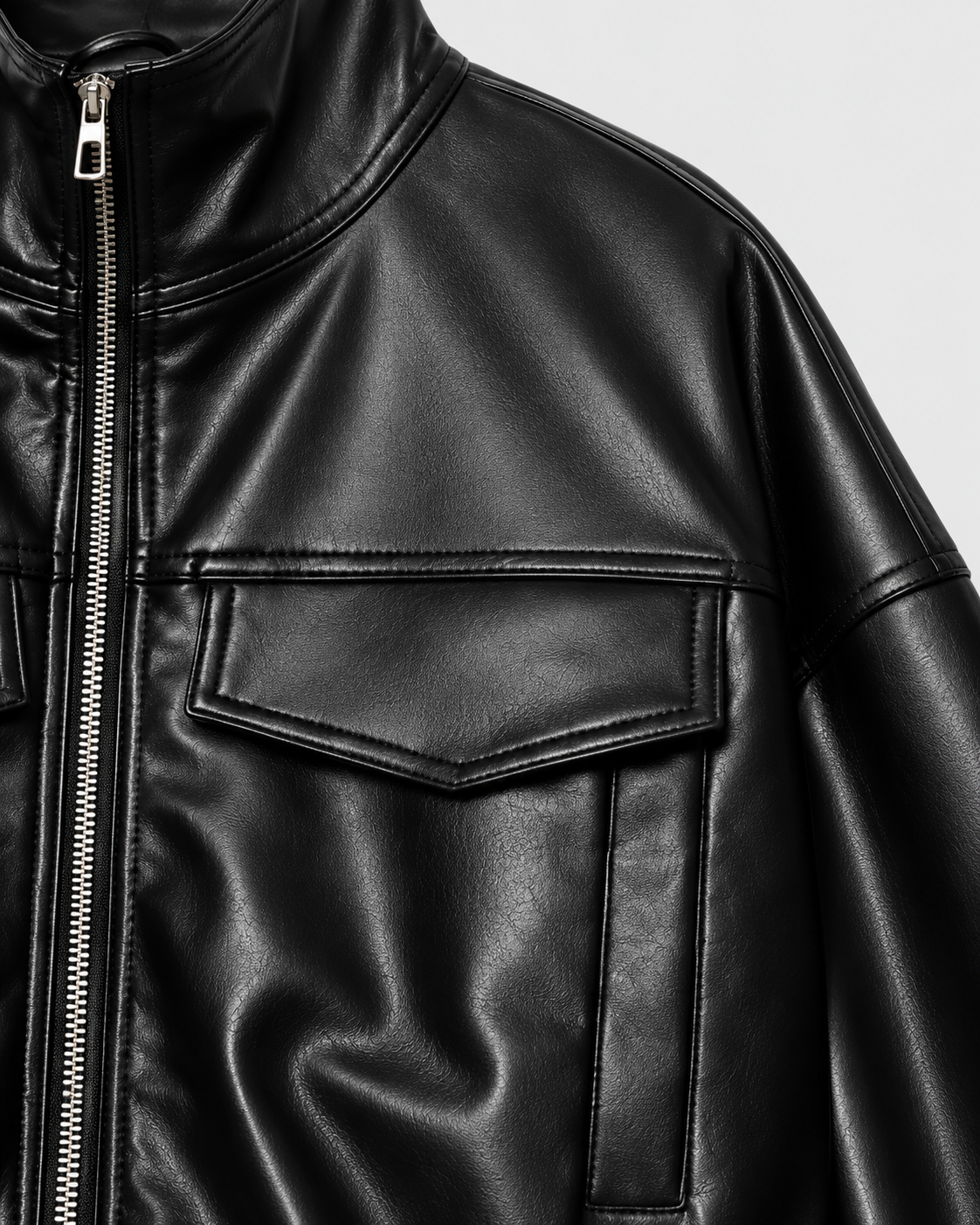 Image of Color: Black | Chest pocket detail on women's black stand collar faux leather jacket