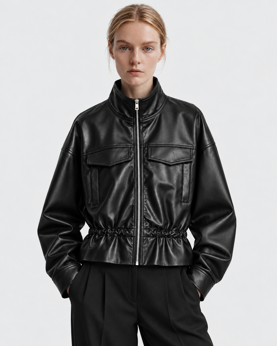 Image of Color: Black | Women's black stand collar faux leather zip-up jacket styled on model, front view