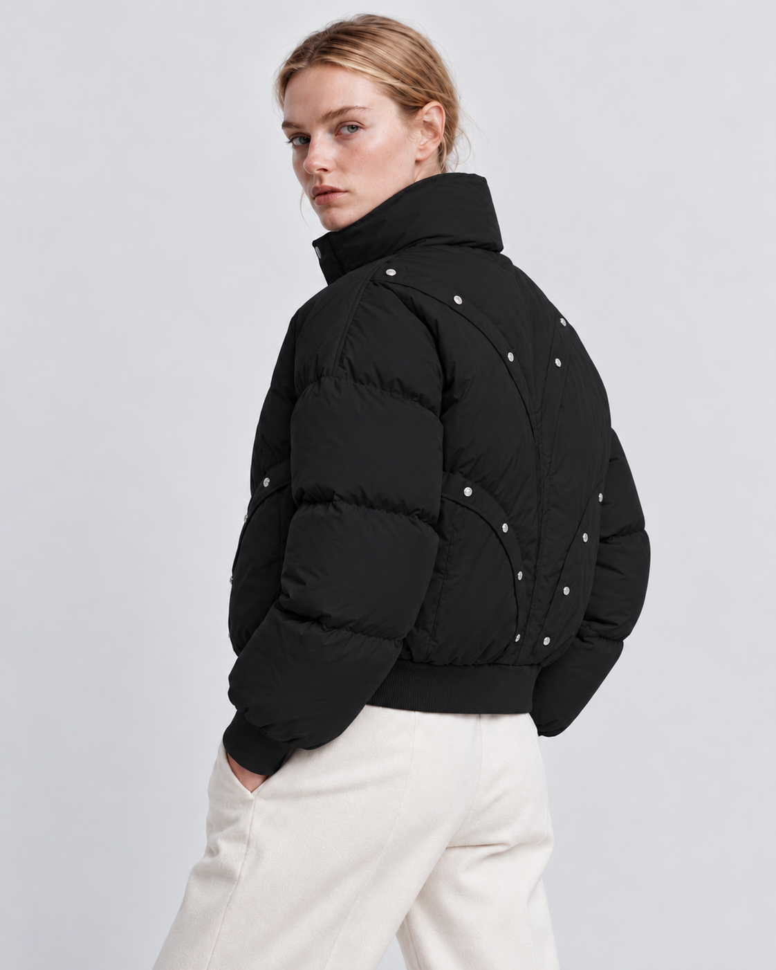 Image of Color: Black | Women's black stand collar quilted puffer jacket on model, back three-quarter view