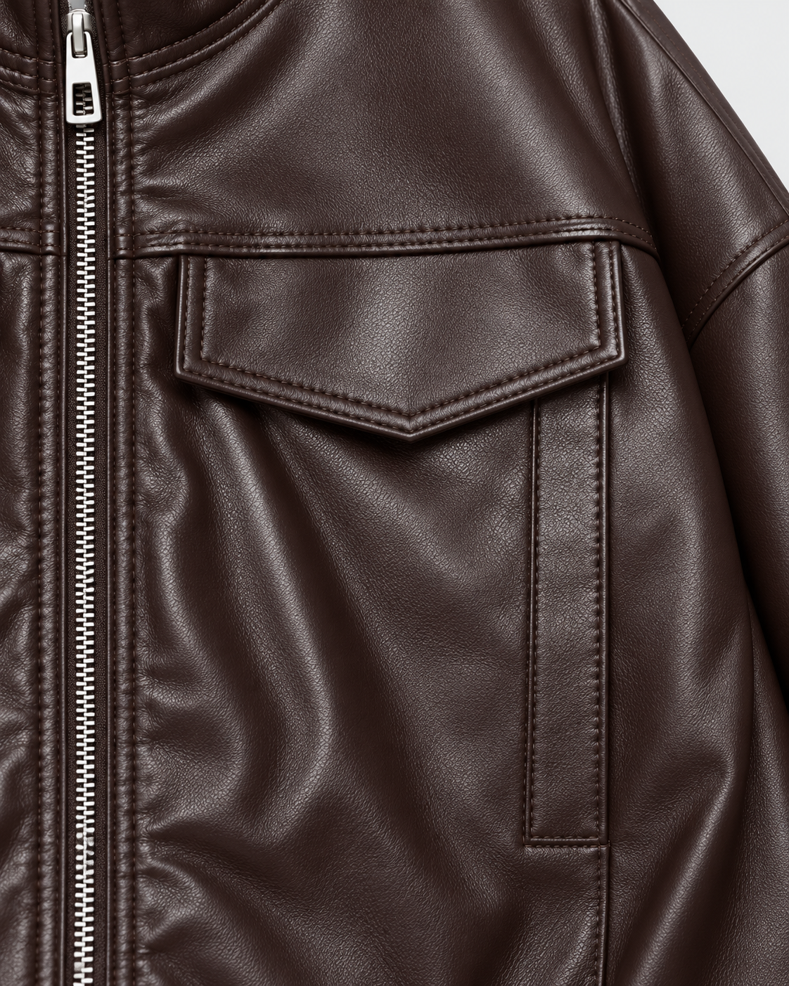 Image of Color: Brown | Chest pocket detail on women's brown stand collar faux leather jacket