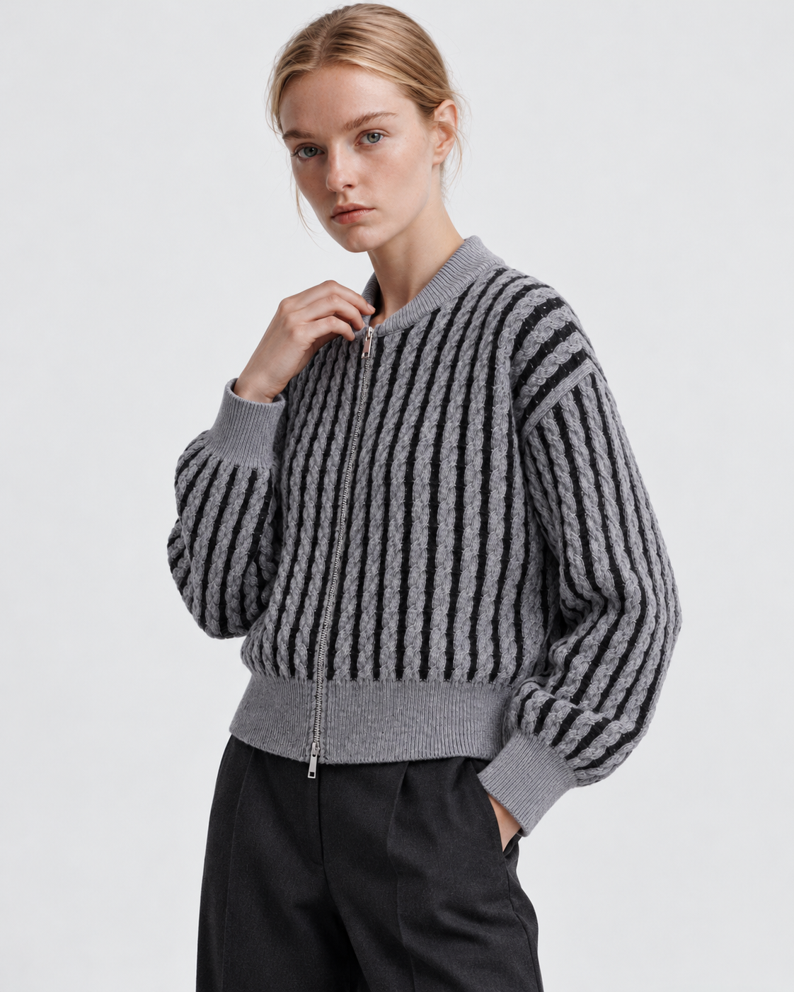 Color: Gray | Women's gray striped cable knit zip-up cardigan styled on model, three-quarter view